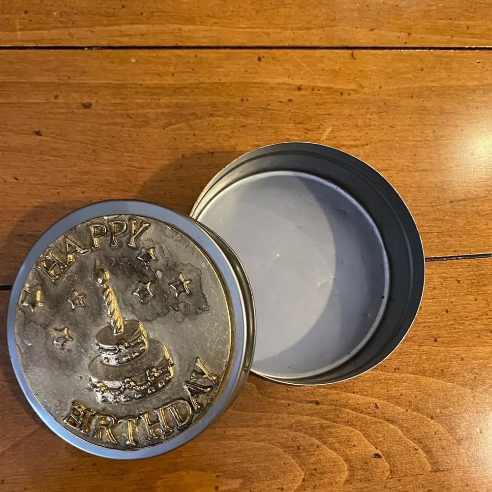 Set of animal candle holders stored in a metal tin.
